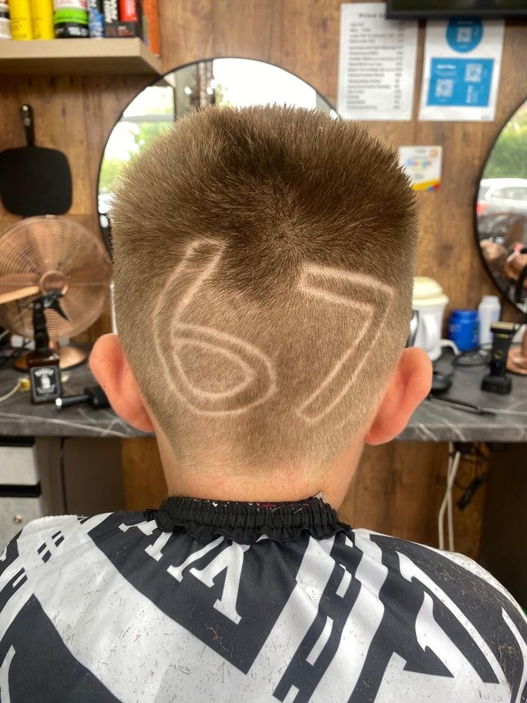 A back-of-head fade with a number pattern shaved in